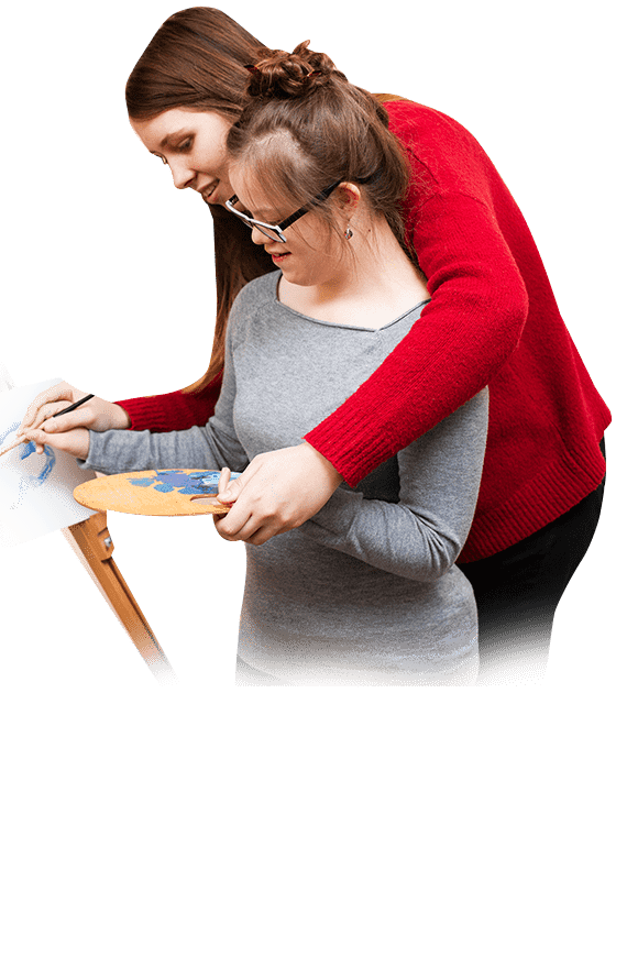 A child and Learning Support Assistant engaged in a creative learning session